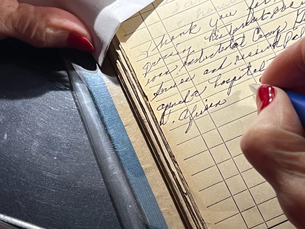 Doris Howard signing The Log Book