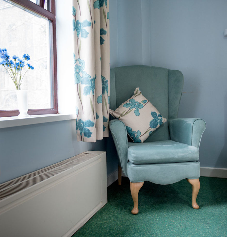 light blue armchair and white and blue curtains