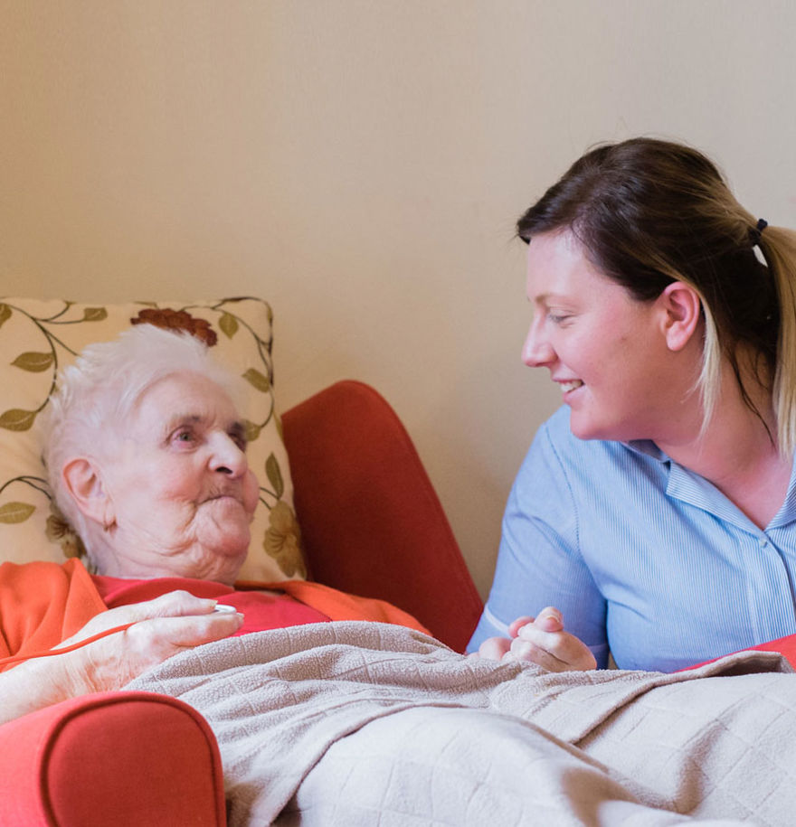 team member and female resident talking