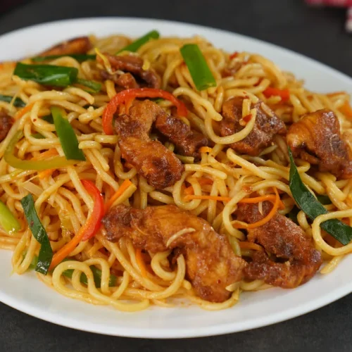 hicken chow mein served in a white bowl with chopsticks