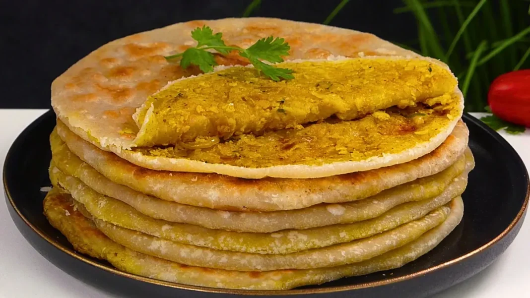 A sliced gobi paratha revealing cauliflower stuffing inside