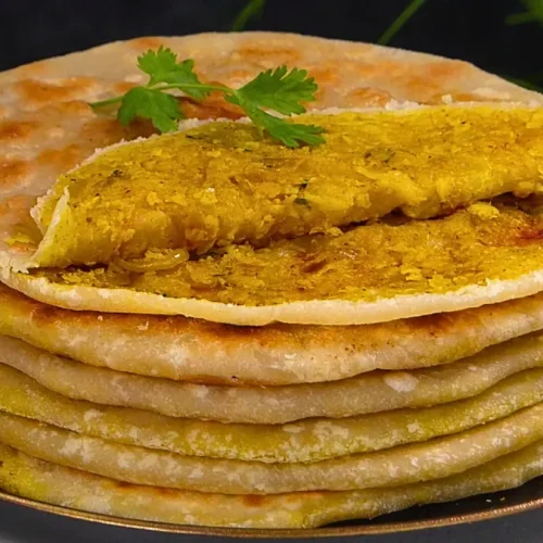 A sliced gobi paratha revealing cauliflower stuffing inside