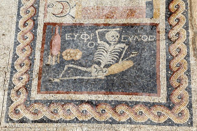 HATAY, TURKEY - APRIL 20: 2,400 year-old mosaic, discovered during excavations, saying "Be cheerful, enjoy your life" in Ancient Greek language is seen in southern Hatay province of Turkey, on April 20, 2016. Mosaic depicts lying down skeleton with a jorum in his hand together with a wine pitcher and bread. (Photo by Halit Demir/Anadolu Agency/Getty Images)