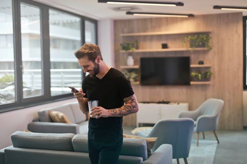 Trader using his cellphone to trade commodities online.