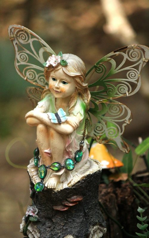 Statue of a little fairy in the back of the garden