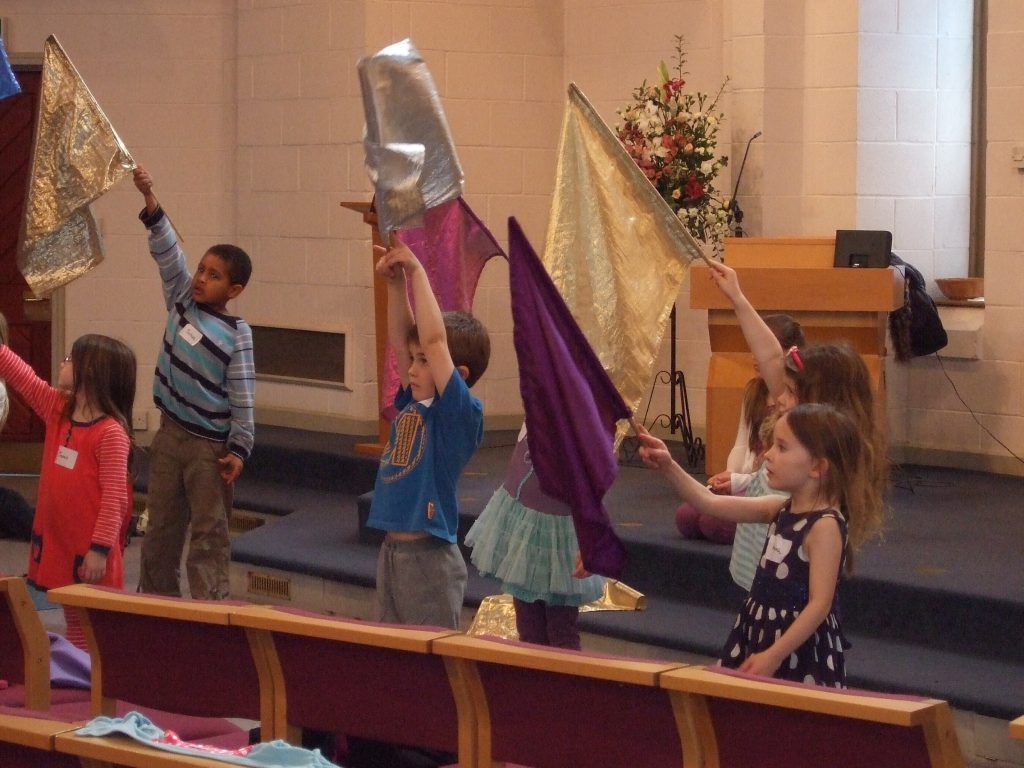 Children's worship with flags.