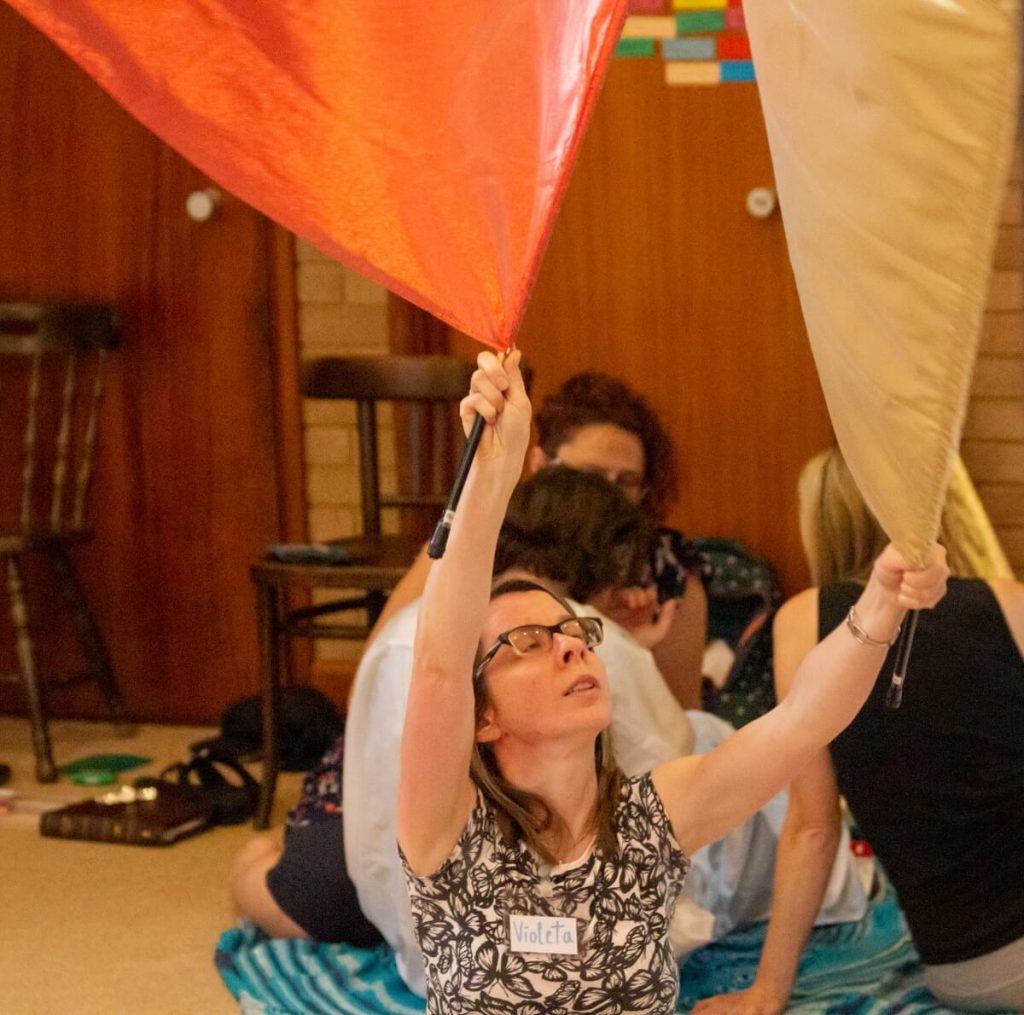 Christian dance holding flags between finger and thumb.