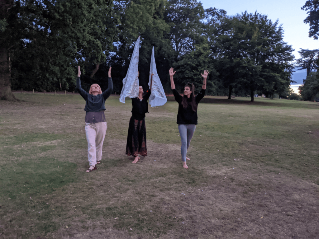 lory to God - dancing outside with a silver flag worshipping God.