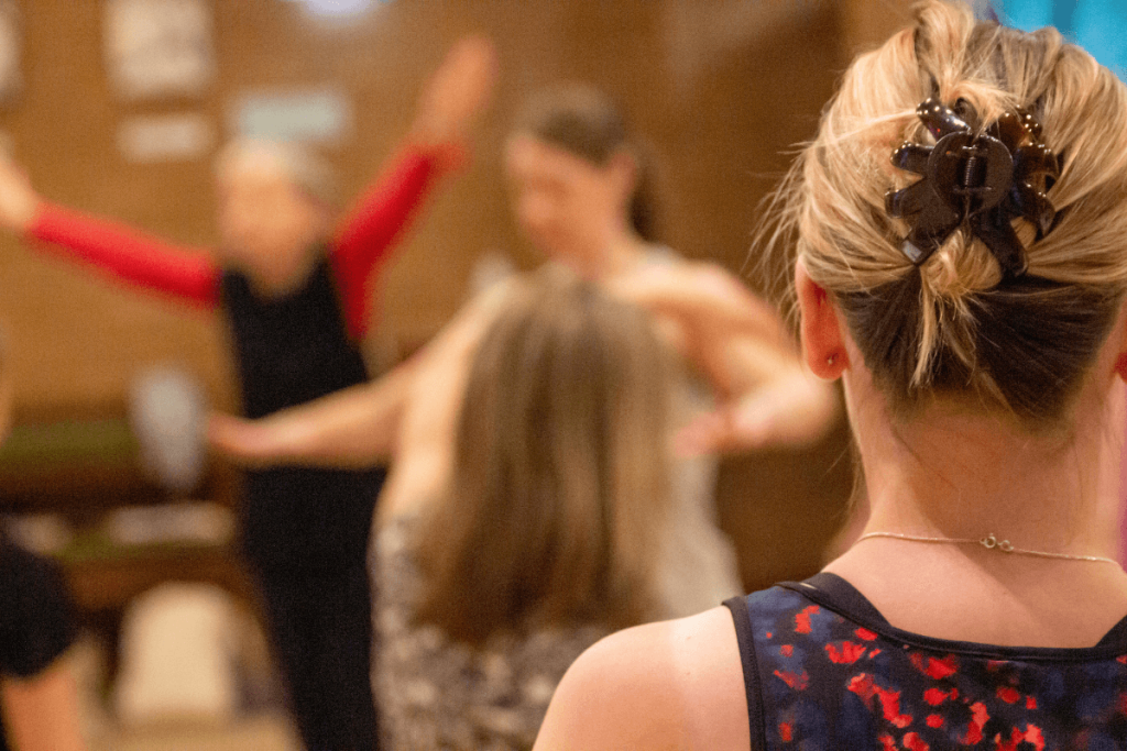 Anna Gilderson standing at the front of a workshop leading a dance ministry