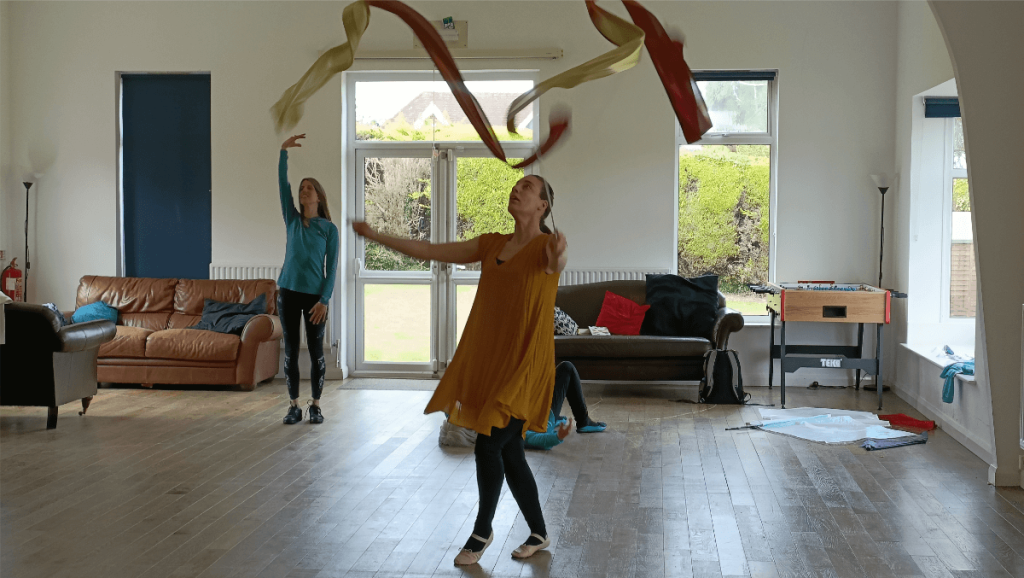 Lady dancing with worship dance streamers coloured brown and bronze.