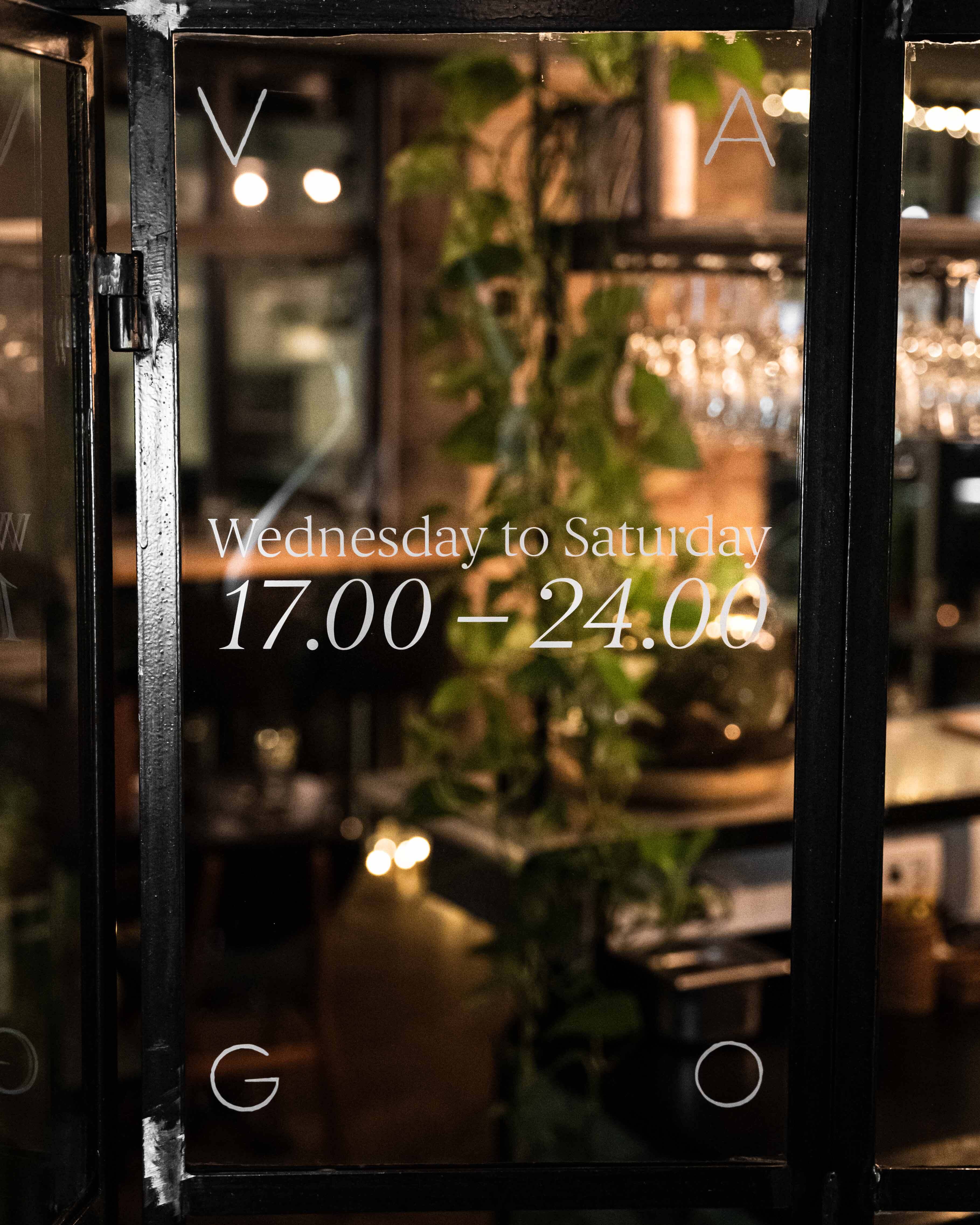 Window with opening hours written on Window with opening hours written on