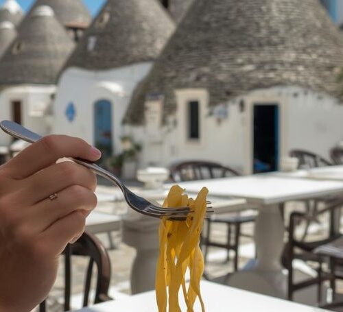 Person eating pasta in Alberobello