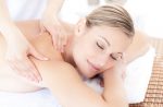 Beautiful woman receiving a back massage in a Spa center