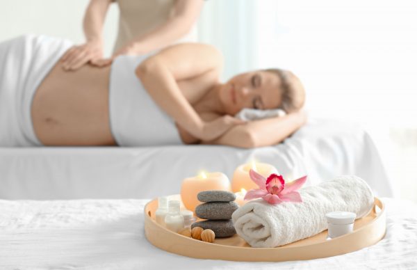 Beautiful spa composition and blurred pregnant woman on background