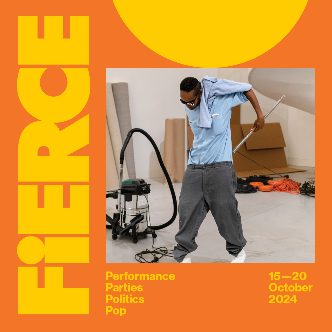 A graphic with an orange background and yellow text. Fierce. Performance parties politics pop. 15-20 October 2024. An image of a person holding a broom handle behind their back, with a vacuum cleaner to their right. In the background are cardboard boxes.