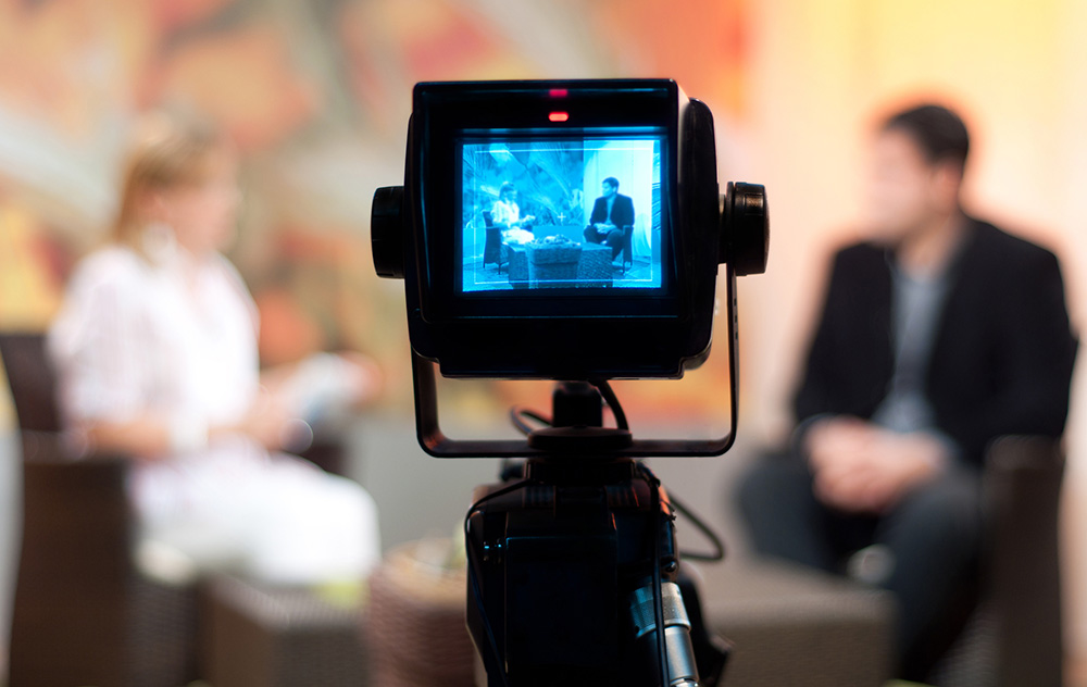 Interview - recording show in TV studio - focus on camera