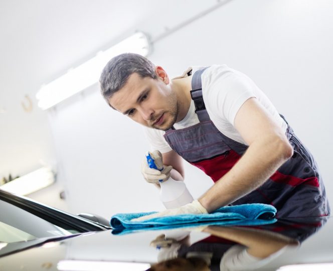 Polishing car with spray and microfibre cloth