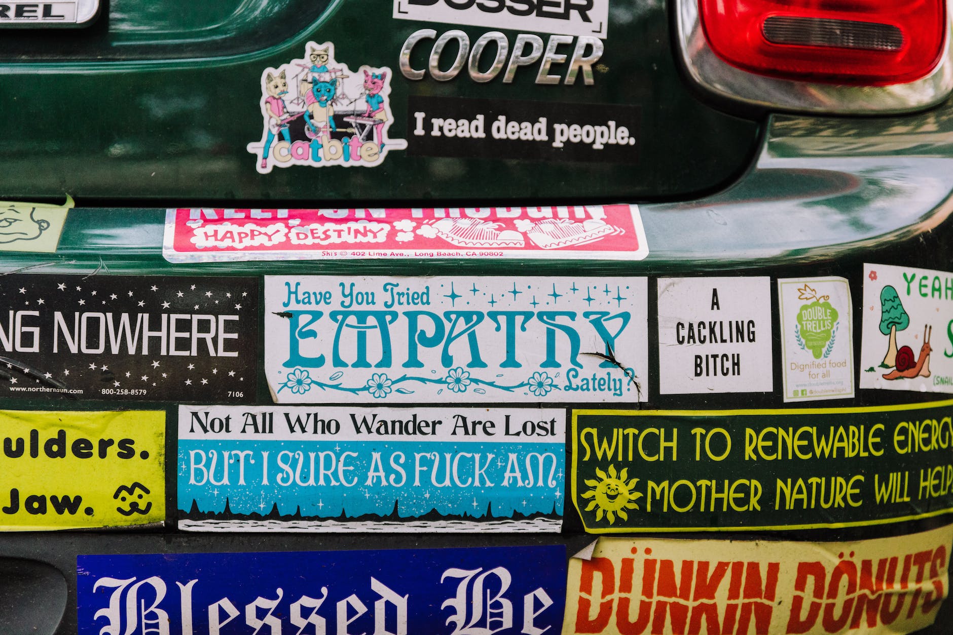 rear bumper of a car covered with colorful stickers