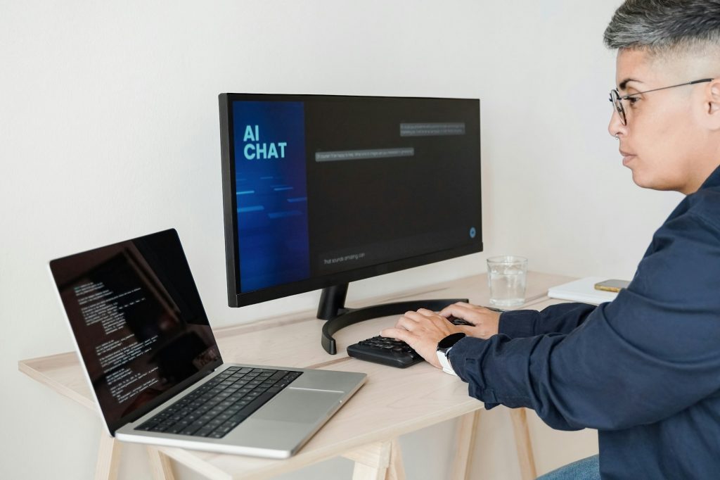 AI chatbot: Programmer using artificial intelligence for software development inside office
