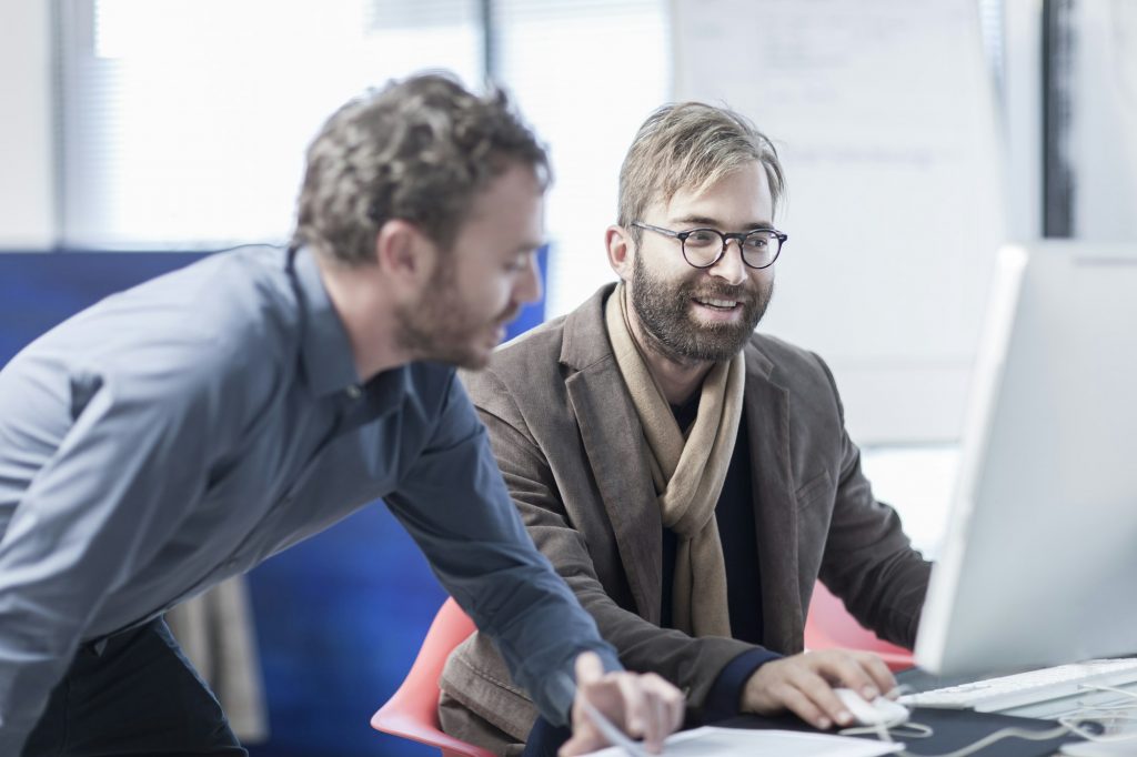 Two men working on a computer