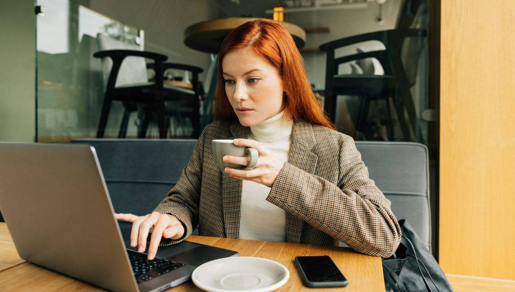 Woman working as a digital nomad in a cafe