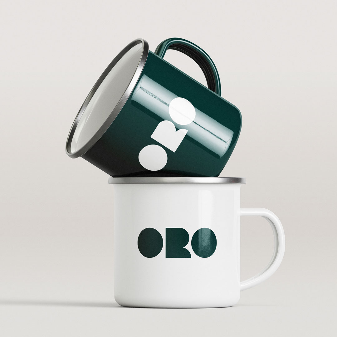 ORO branded enamel coffee mugs designed by Bart De Keyzer featuring minimalist logo application and premium merchandise branding. Contemporary coffee brand identity created by a freelance graphic designer and illustrator specializing in branding and packaging design.