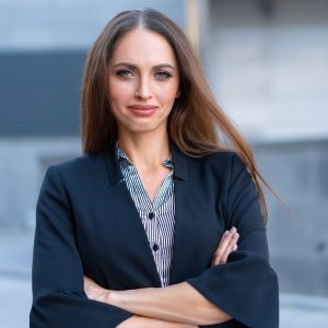 Business smiling woman dressed jacket standing outdoor Business portrait Hands crossed Business smiling woman dressed jacket standing outdoor Business portrait Hands crossed
