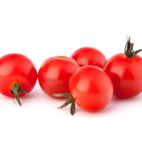 Small cherry tomato on white background close up