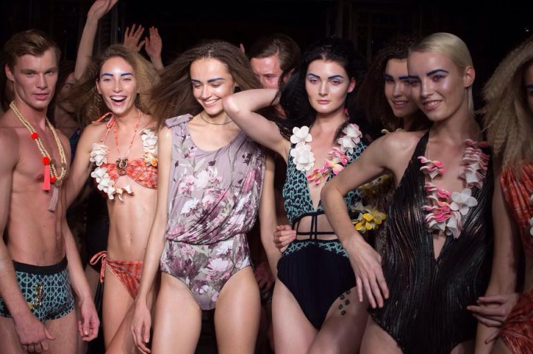 A photo of a group of male and female models on the catwalk at LFW, wearing swimwear