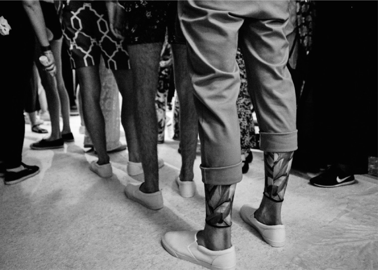A phot of male models legs backstage at LFW