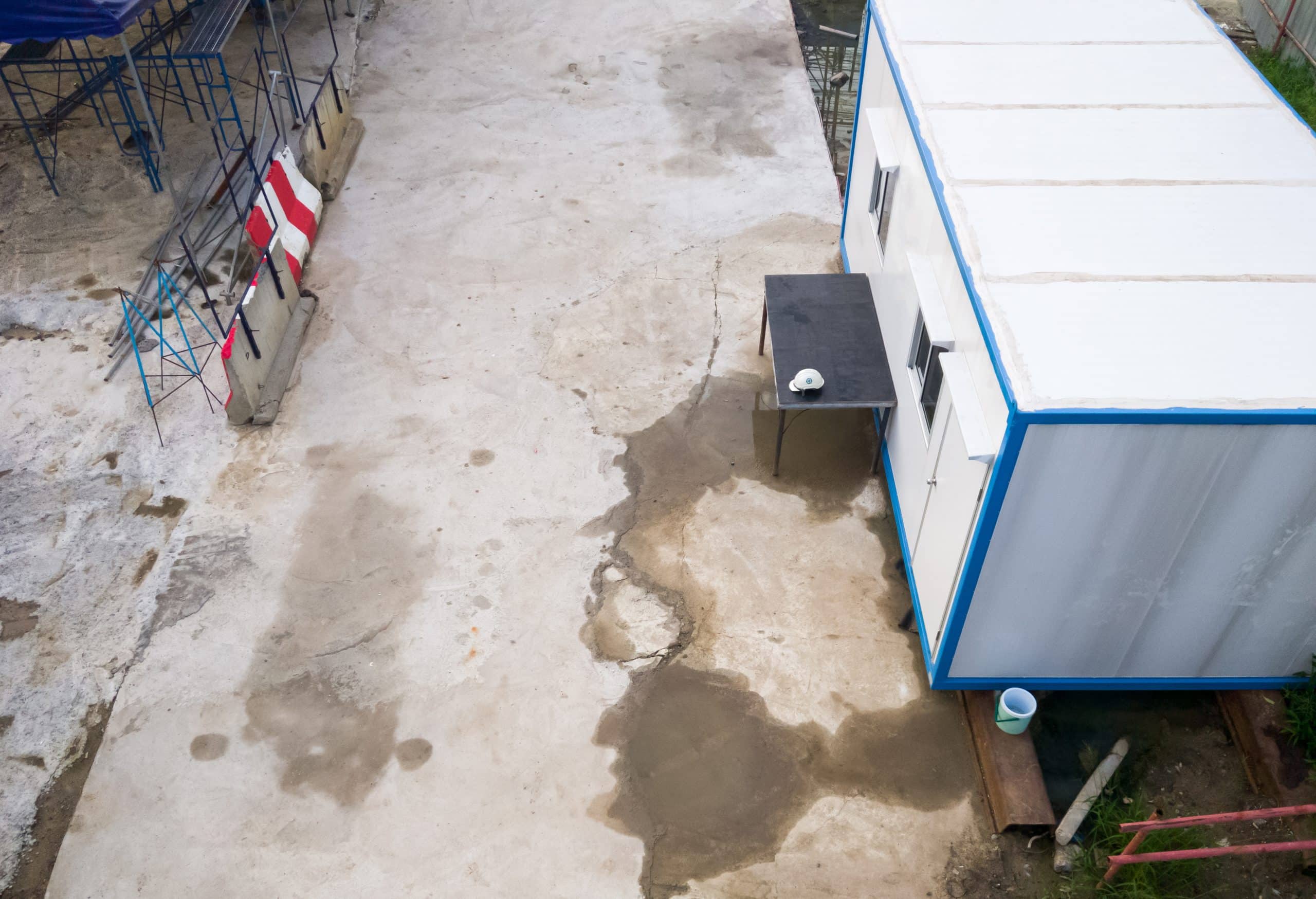 The temporary container box for use to the office room in the construction site, near the monorail project in the city, above view with the copy space.