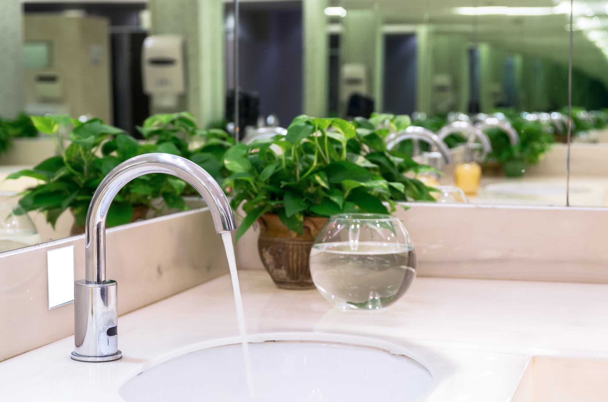 Chrome faucet with washbasin in modern bathroom