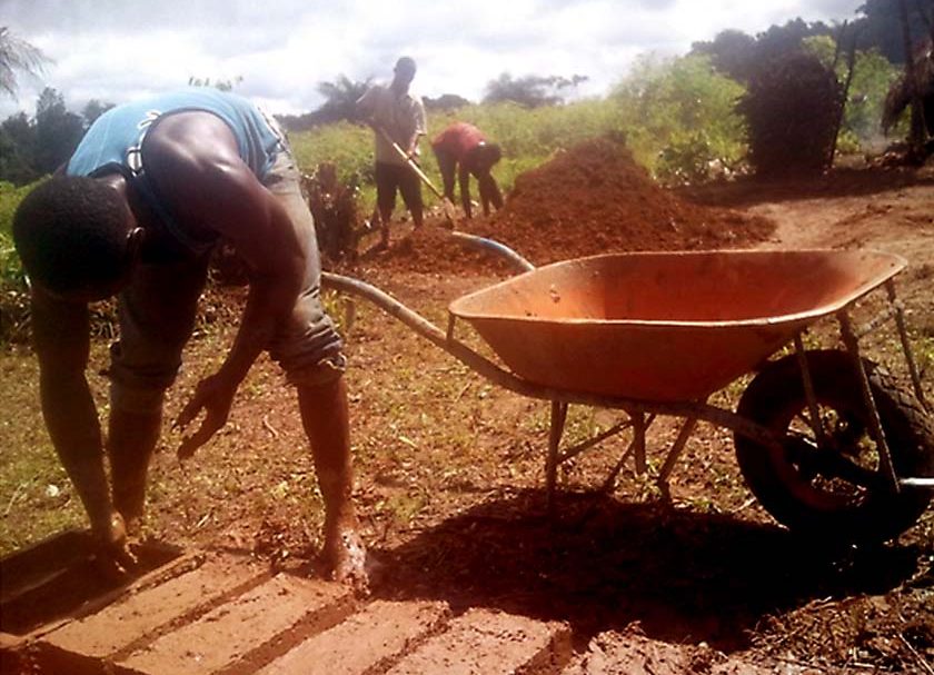 Former child soldiers in Liberia making bricks, reintegration program