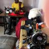 Dollas creation workshop with tailoring machines and an assistant working