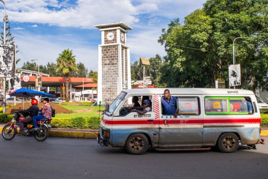A van driving on the street, with people inside, symbolizing a small-business entrepreneur in Africa