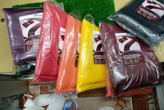 Textile products in plastic bags in a small retail shop in Kenya