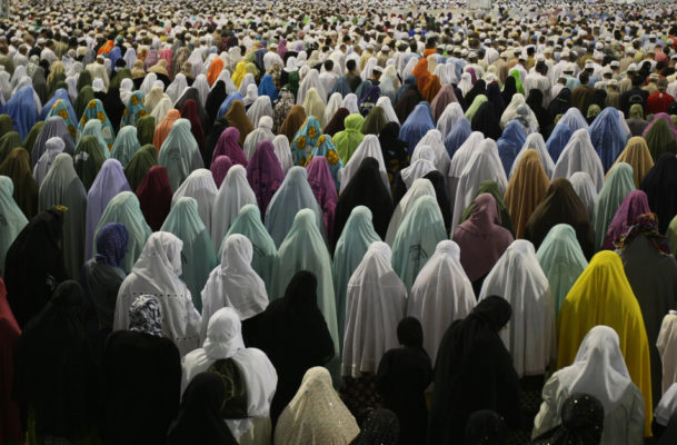 Muslim women pray outside Mecca's Grand Mosque on November 15, 2009. Some 2.5 million Muslims from more than 160 countries converge annually on the Islamic holy cities of Mecca and Medina in western Saudi Arabia. The hajj pilgrimage -- to be completed at least once in a Muslim's lifetime, under the tenets of Islam -- can be undertaken at any time, but peaks this year from November 25 to 29, at the height of the alert over swine flu. AFP PHOTO/MAHMUD HAMS (Photo credit should read MAHMUD HAMS/AFP/Getty Images)