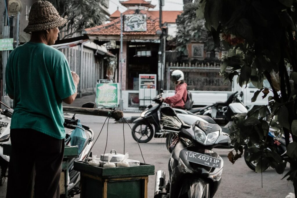 Man Standing Beside Black Motorcycle