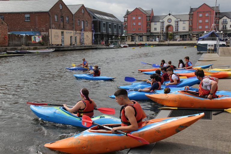 Kayakers sliding on river Exe