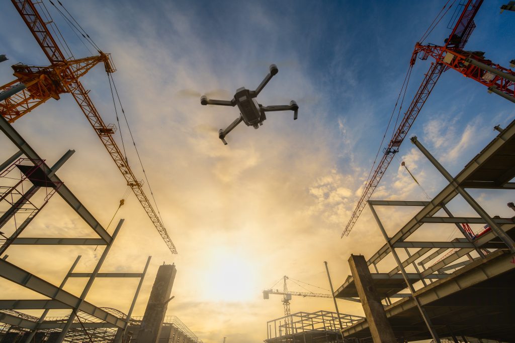 Drone over construction site. video surveillance or industrial inspection