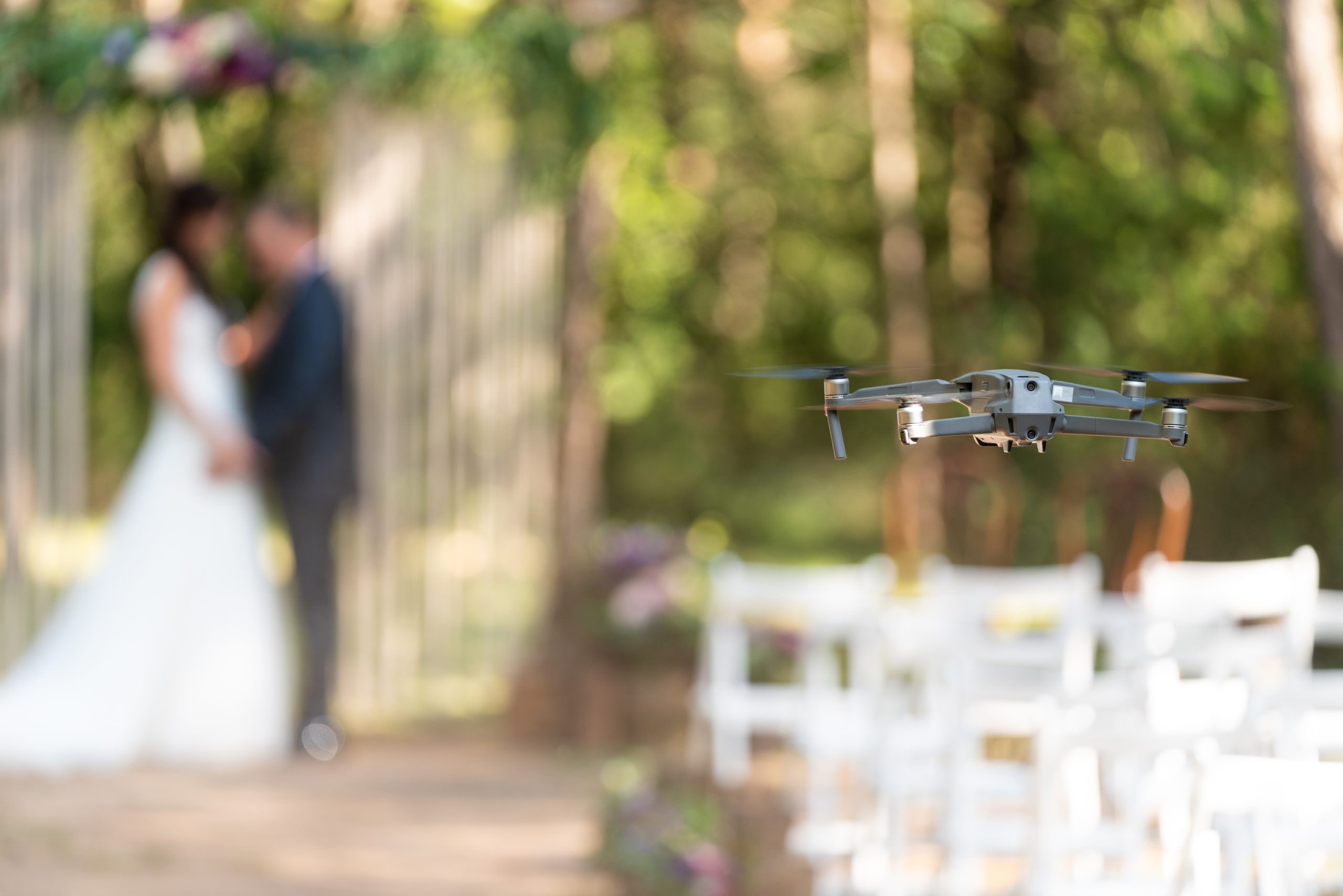 Small grey drone filming and photographing a wedding