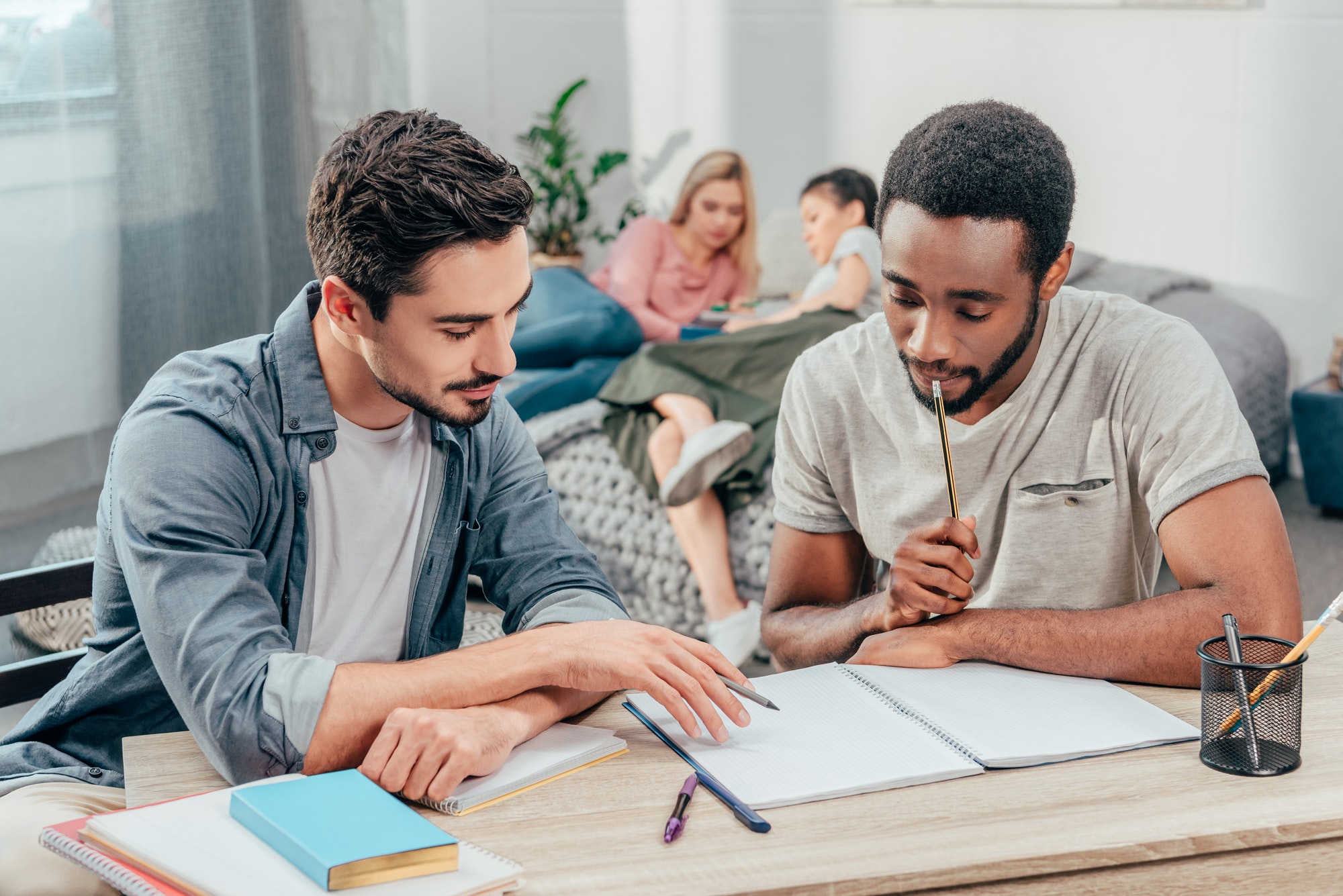 young focused students studying at home