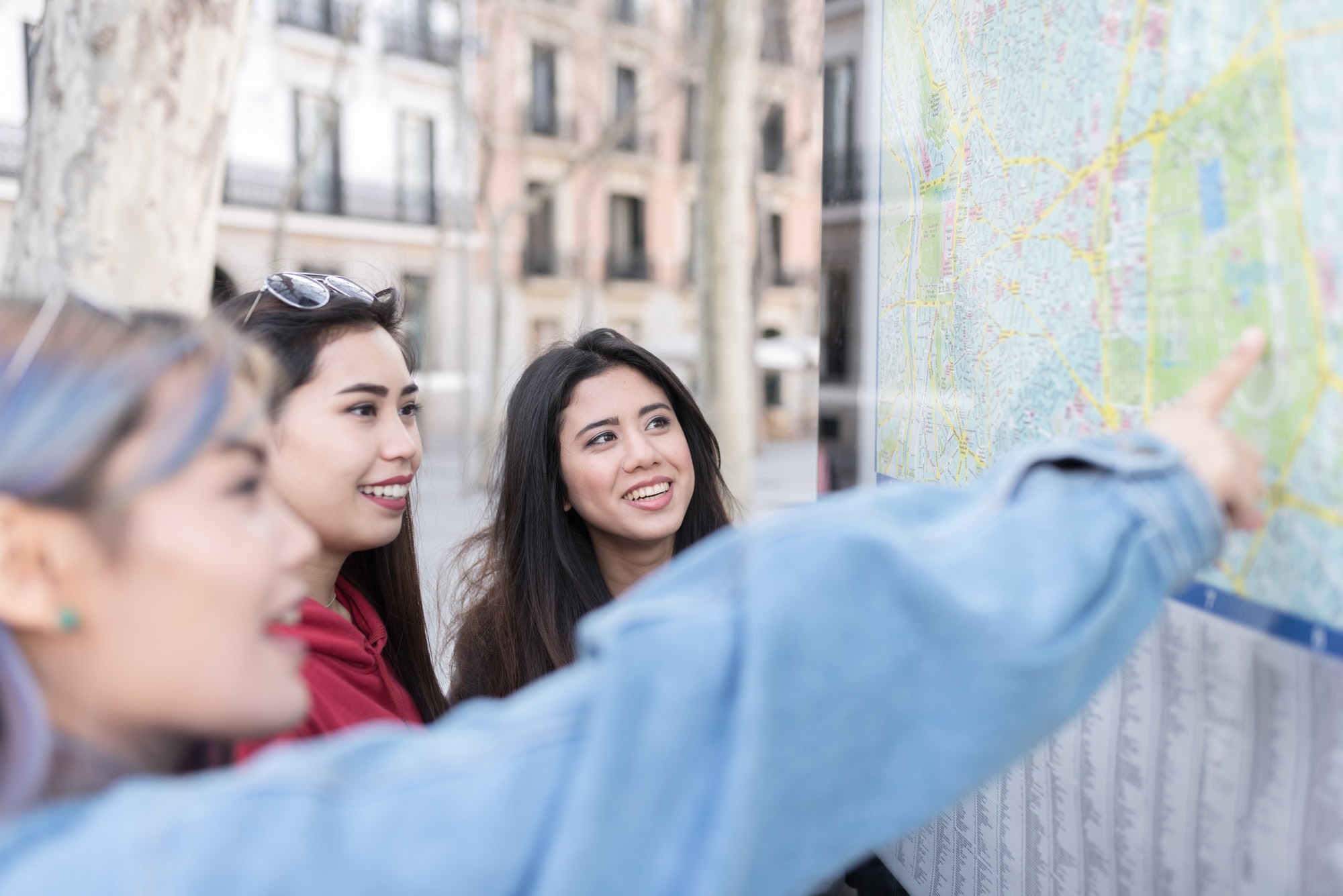 philippine friends women in Madrid looking a map on the street