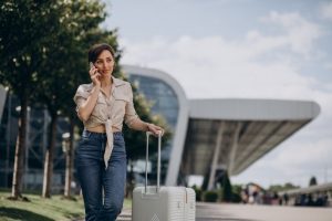 Vrouw die reist met bagage voor personenvervoer op luchthaven