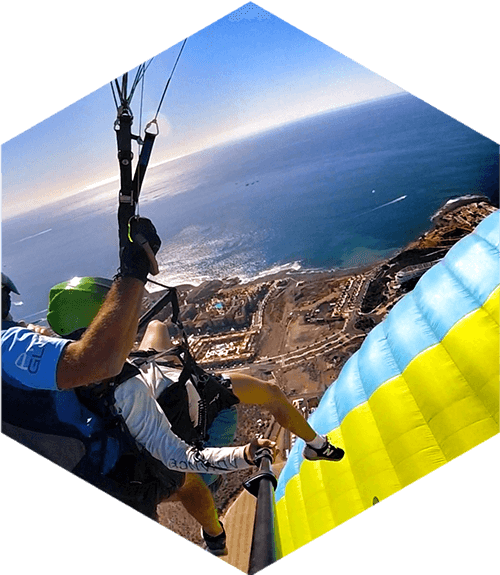 tandem paragliders over the coast