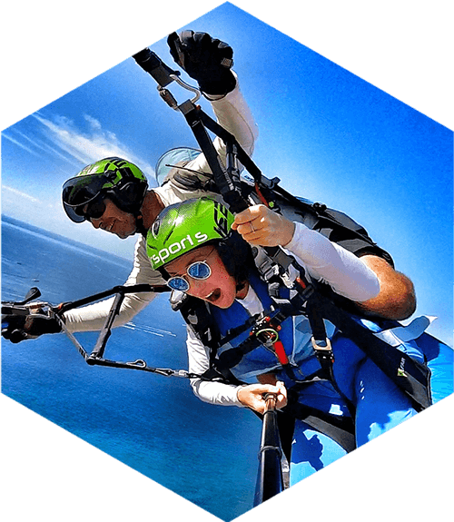 tandem paragliders over the sea