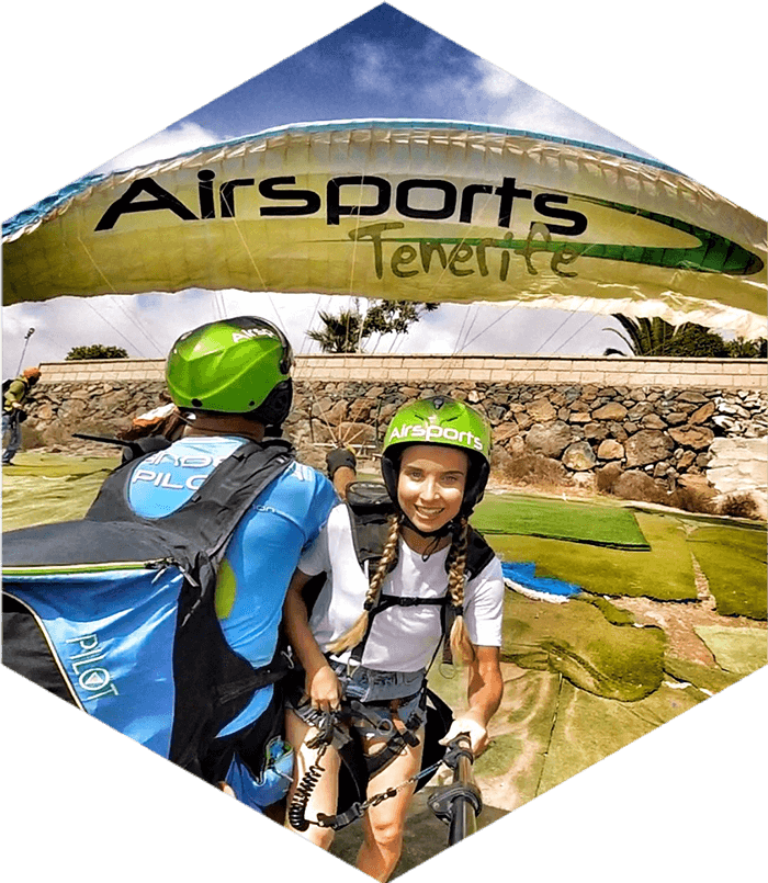 paraglider pilot and girl on the ground