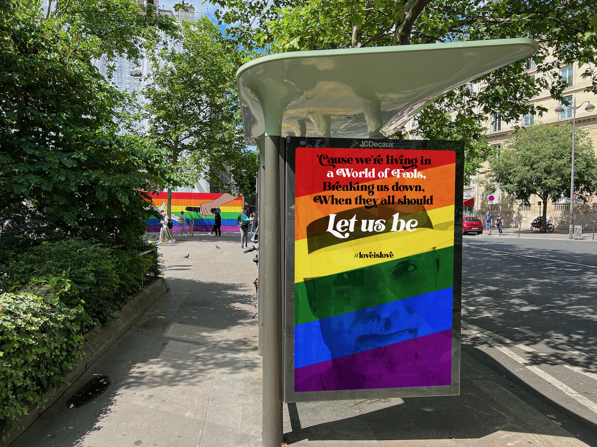 Pride colored poster in a Paris bus stop frame