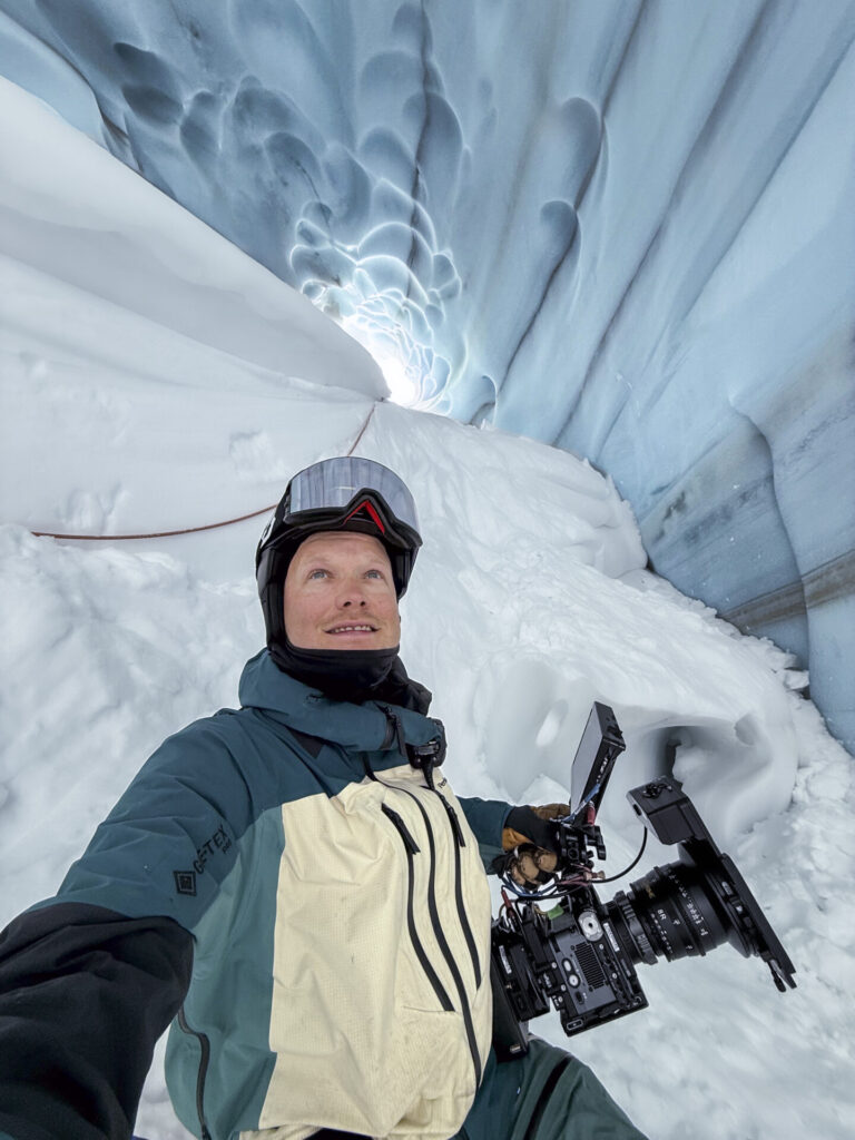 Ski cinematographer Alexander Ryden filming inside an ice cave with professional camera gear