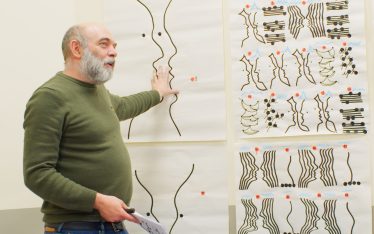 Carlos Amorales in front of his drawings
